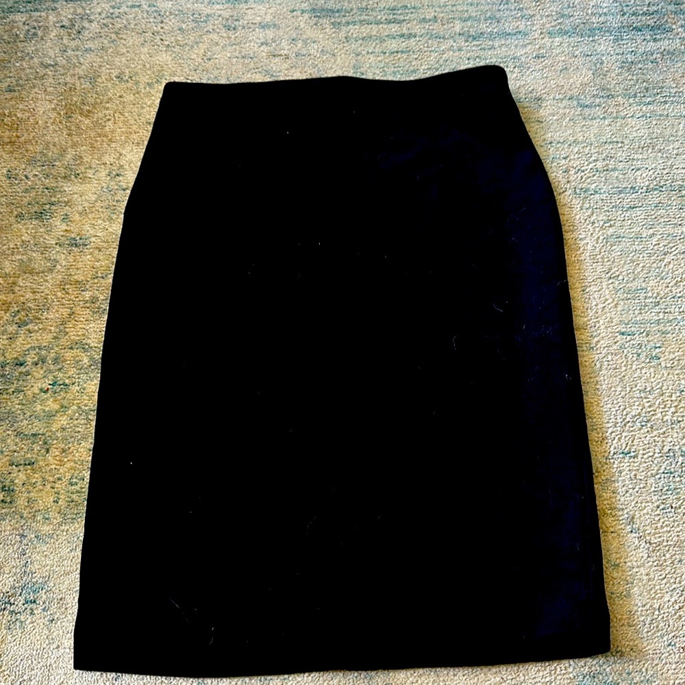 Fitted soft pencil skirt. Never worn. Zipper in back.